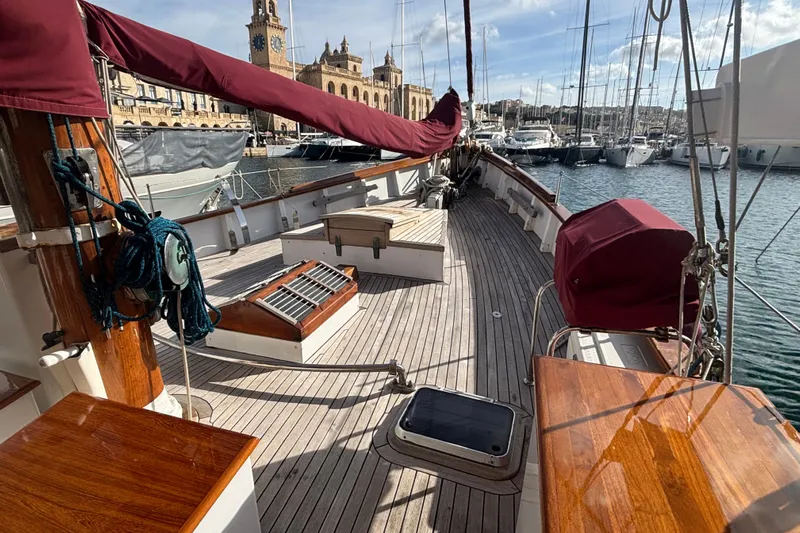 Barinia Yacht Photos Pics Vintage 1950 MOLLICH Sailing boat deck with wooden finish, docked in a marina.