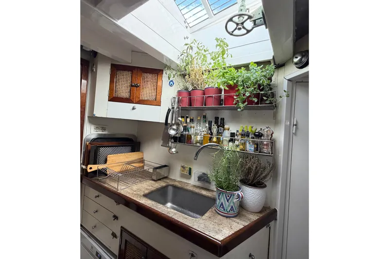 Barinia Yacht Photos Pics 1950 MOLLICH Sailing yacht kitchen with herbs, spices, and vintage decor.