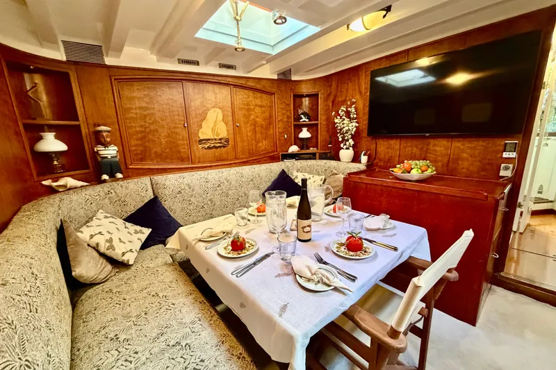 Barinia Yacht Photos Pics Cozy 1950 MOLLICH Sailing yacht interior with elegant dining setup and wooden decor.