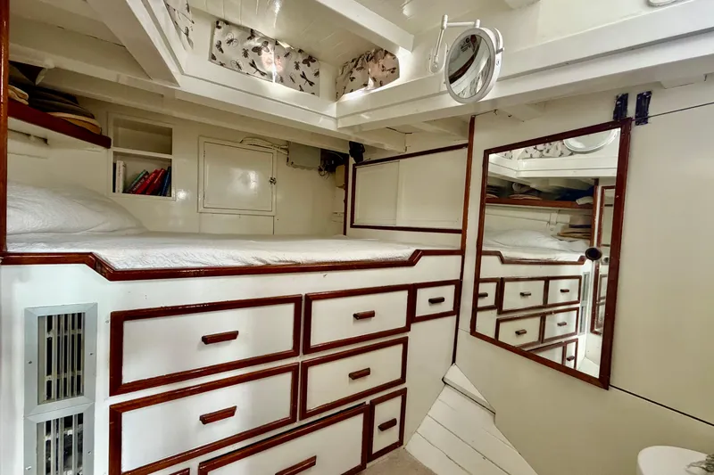 Barinia Yacht Photos Pics Vintage 1950 MOLLICH Sailing yacht interior with wooden cabinetry and cozy sleeping area.