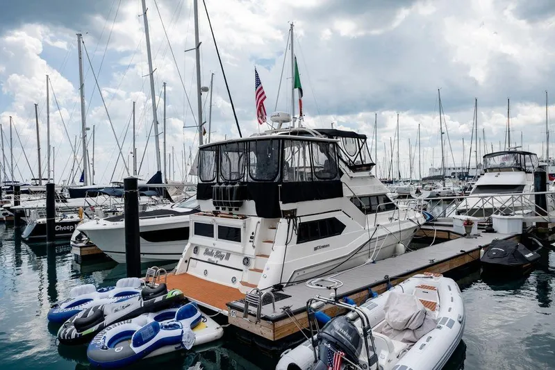 Bada Bing Yacht Photos Pics 1991 Cruisers Yachts 3850 Aft Cabin docked at marina with inflatables nearby.