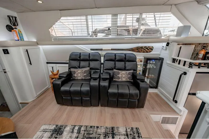 Bada Bing Yacht Photos Pics Luxurious 1991 Cruisers Yachts 3850 Aft Cabin interior with black recliners and mini fridge.