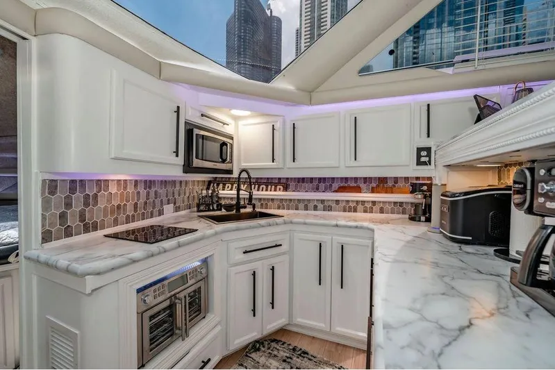 Bada Bing Yacht Photos Pics Luxurious 1991 Cruisers Yachts 3850 Aft Cabin kitchen with modern appliances and marble countertops.