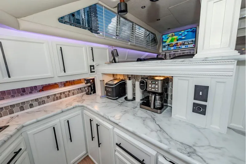 Bada Bing Yacht Photos Pics Luxurious 1991 Cruisers Yachts 3850 Aft Cabin kitchen with modern appliances and marble countertops.