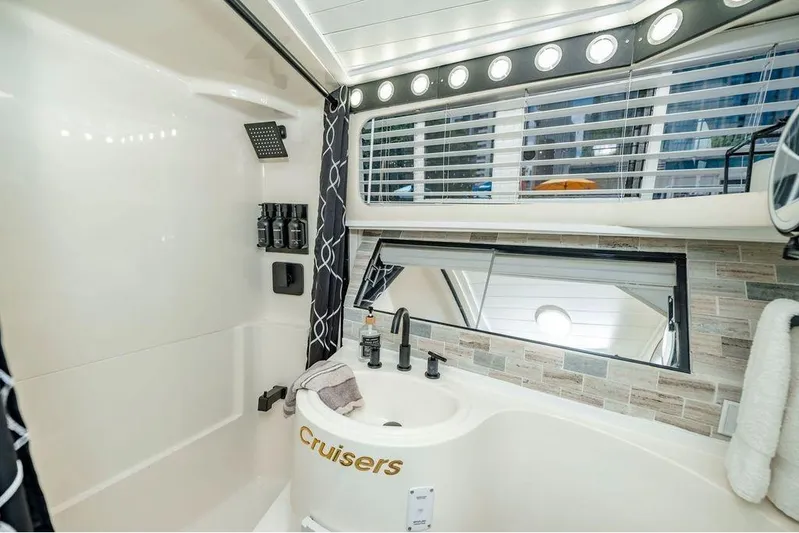 Bada Bing Yacht Photos Pics Luxurious bathroom in 1991 Cruisers Yachts 3850 Aft Cabin with modern fixtures and elegant design.