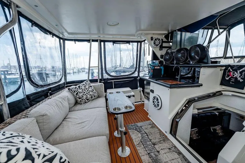 Bada Bing Yacht Photos Pics 1991 Cruisers Yachts 3850 Aft Cabin interior with cozy seating and marina view.