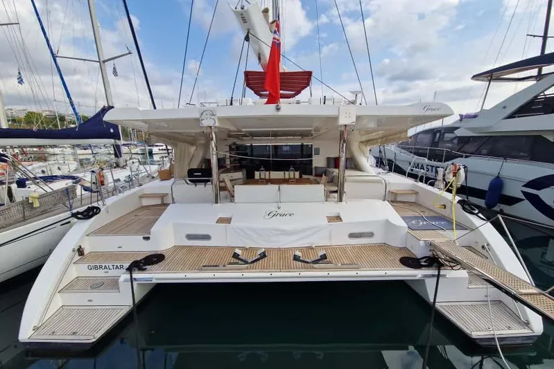 Grace Yacht Photos Pics Luxurious 2013 Sunreef 60 LOFT yacht docked in a marina, showcasing elegant design.