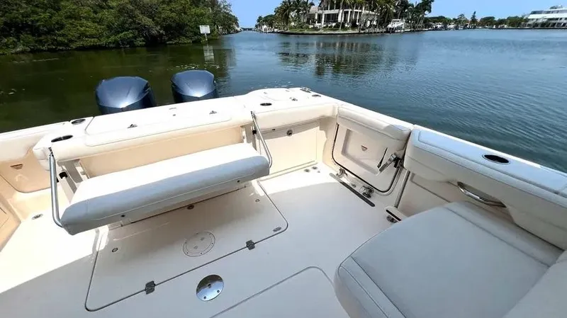  Yacht Photos Pics 2019 Grady-White Freedom 325 boat interior with seating, on a calm waterway.