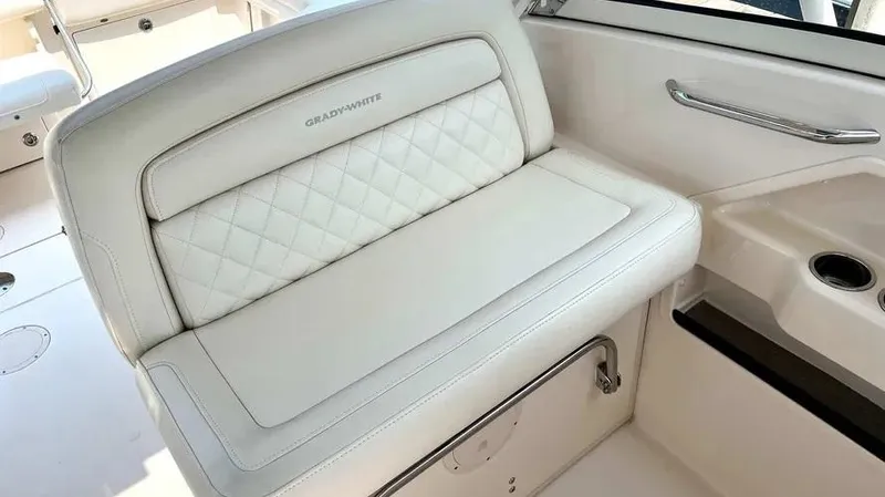  Yacht Photos Pics 2019 Grady-White Freedom 325 boat interior with white cushioned seating.