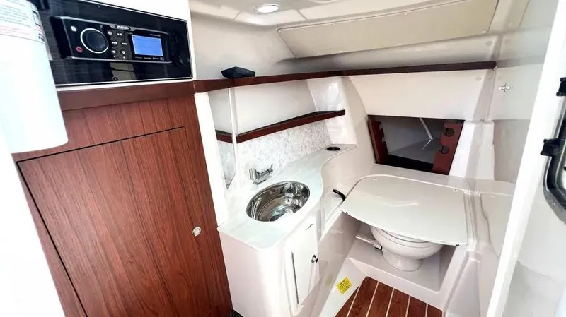  Yacht Photos Pics 2019 Grady-White Freedom 325 boat interior with sink, toilet, and wood accents.