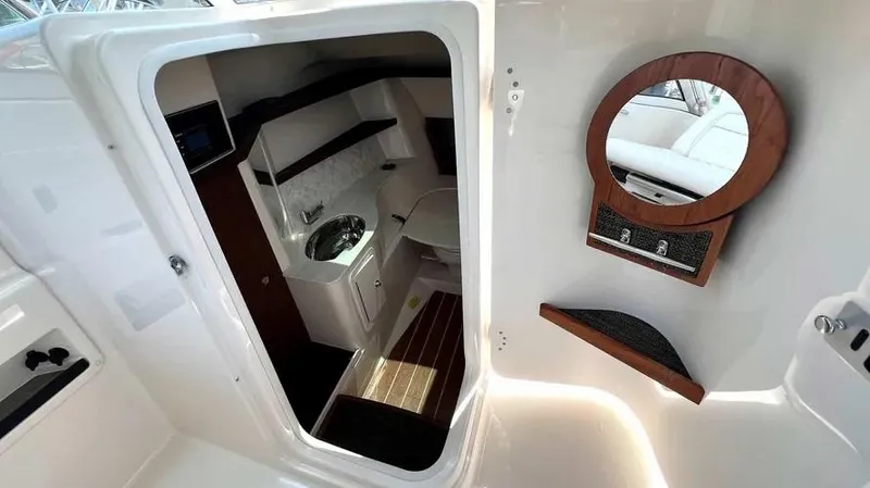  Yacht Photos Pics Interior view of 2019 Grady-White Freedom 325 boat cabin with sink and mirror.