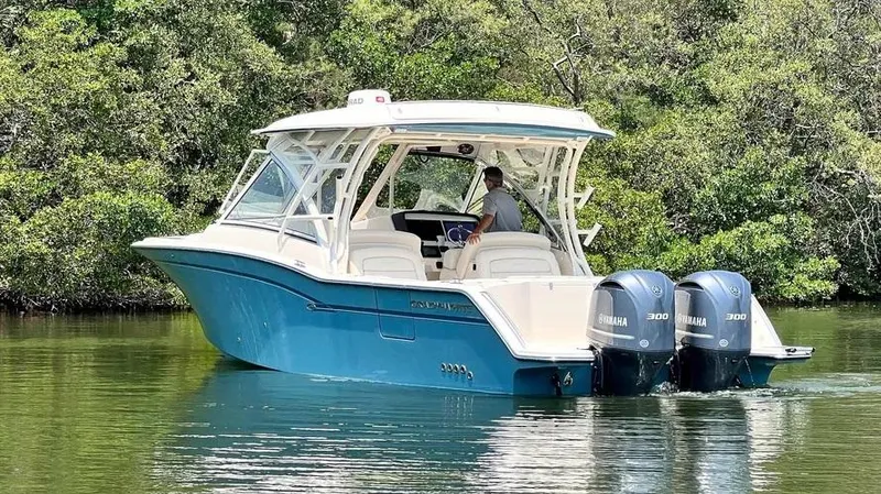  Yacht Photos Pics 2019 Grady-White Freedom 325 boat with dual Yamaha engines on a calm waterway.