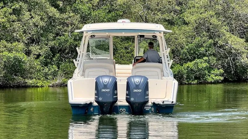  Yacht Photos Pics 2019 Grady-White Freedom 325 boat with dual engines on a calm waterway.