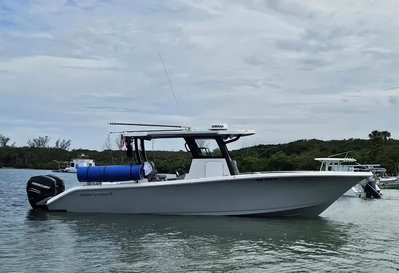 Dealer Demo Yacht Photos Pics 2023 Sea Pro 320 DLX Center Console boat on calm water, with Mercury engines.