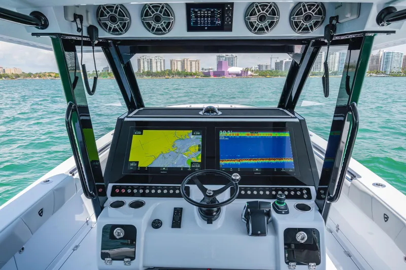  Yacht Photos Pics 2026 Barker Boatworks 40HPC helm with advanced navigation displays and city skyline view.