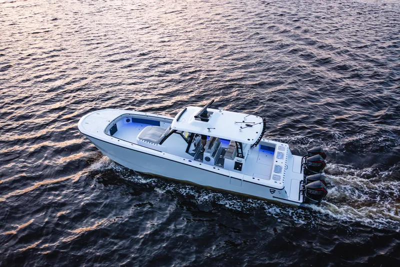  Yacht Photos Pics 2026 Barker Boatworks 40HPC cruising on open water at sunset.