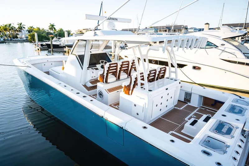  Yacht Photos Pics 2026 Barker Boatworks 40HPC in marina, showcasing sleek design and spacious deck.