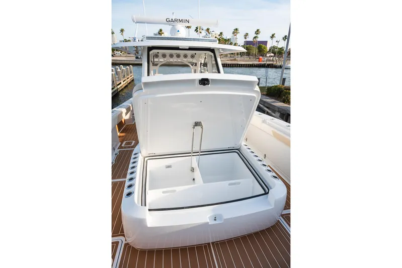  Yacht Photos Pics 2026 Barker Boatworks 40HPC open storage compartment on deck, docked by water.