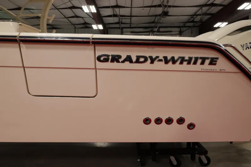  Yacht Photos Pics 2026 Grady-White Freedom 325 boat side view in indoor showroom.