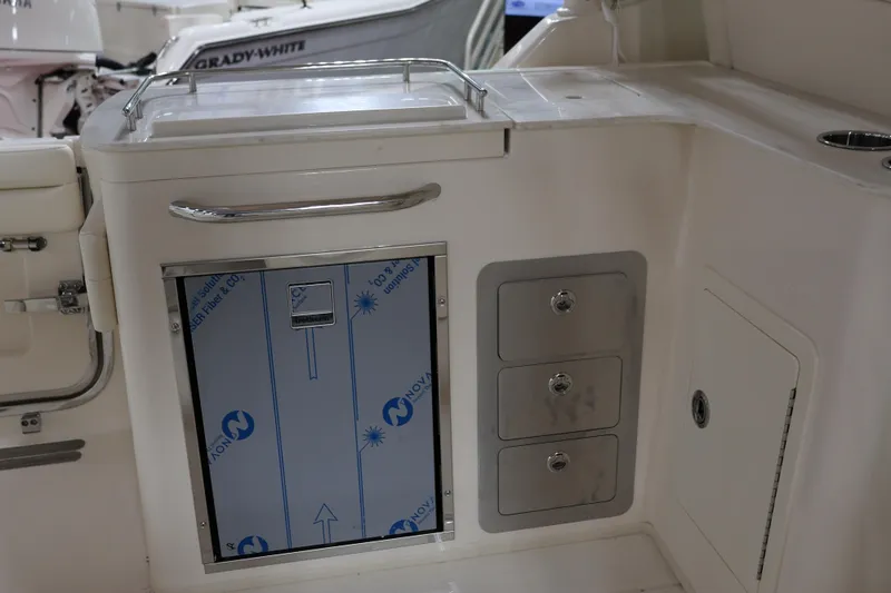  Yacht Photos Pics 2026 Grady-White Freedom 325 boat interior with storage compartments and stainless steel fixtures.