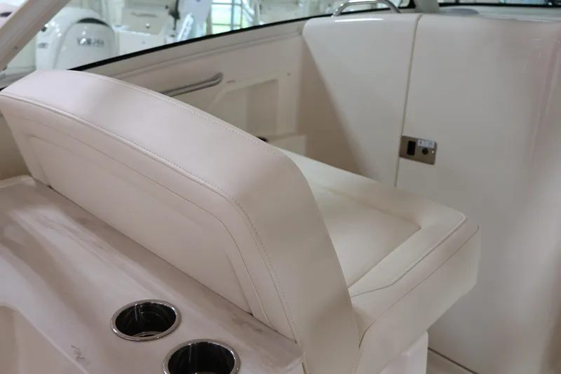  Yacht Photos Pics 2026 Grady-White Freedom 325 boat interior with beige seating and cup holders.