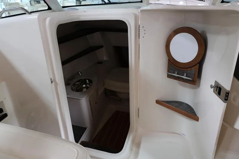  Yacht Photos Pics 2026 Grady-White Freedom 325 boat interior with compact bathroom and sink.