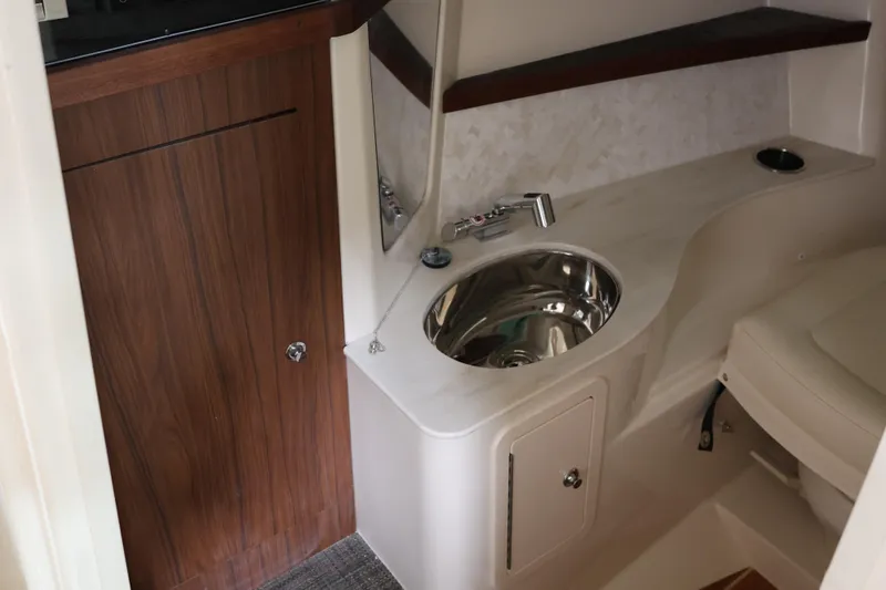  Yacht Photos Pics 2026 Grady-White Freedom 325 boat interior with sink and wooden cabinet.