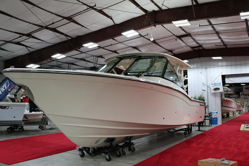  Yacht Photos Pics 2026 Grady-White Freedom 325 boat displayed indoors on red carpet.