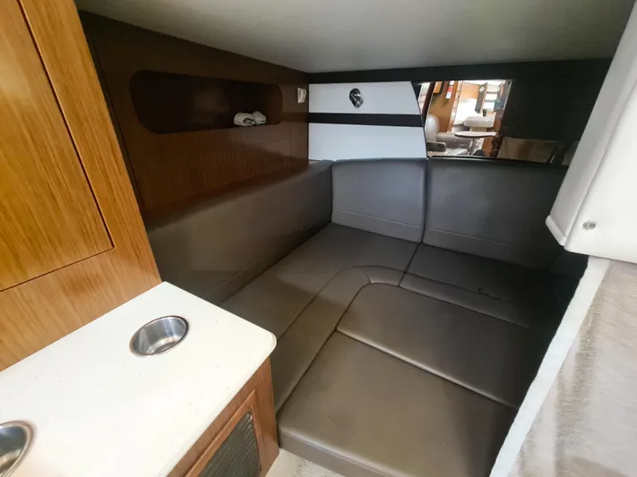2015 Cruisers Yachts 350 Express Yacht Photos Pics Interior of 2015 Cruisers Yachts 350 Express with brown leather seating and wooden cabinetry.