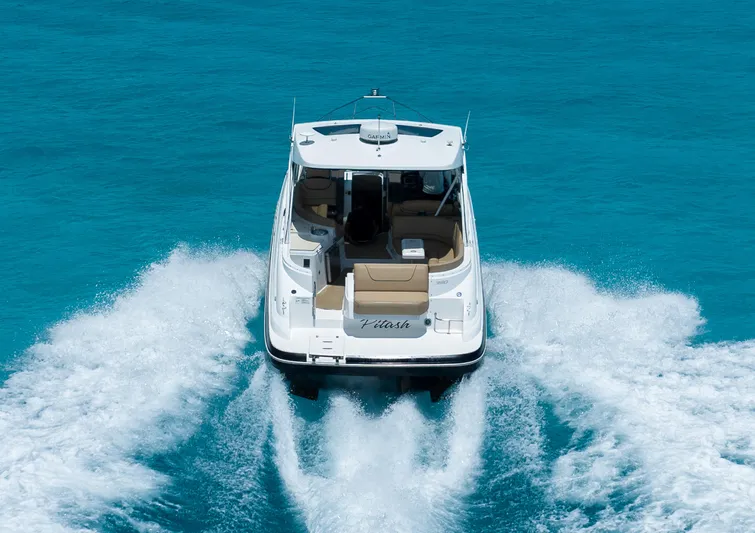 2015 Cruisers Yachts 350 Express Yacht Photos Pics 2015 Cruisers Yachts 350 Express cruising on clear blue water, rear view.