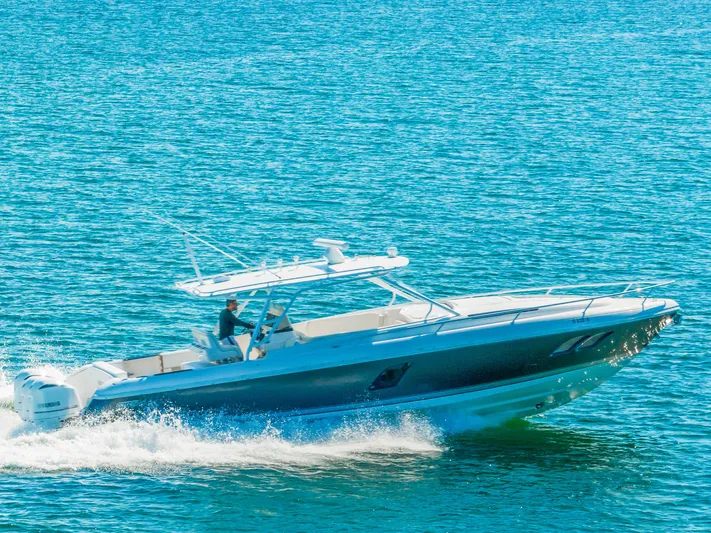  Yacht Photos Pics 2016 Intrepid 400 Cuddy cruising on clear blue water.