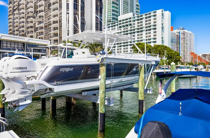  Yacht Photos Pics 2016 Intrepid 400 Cuddy boat docked in a marina with cityscape background.