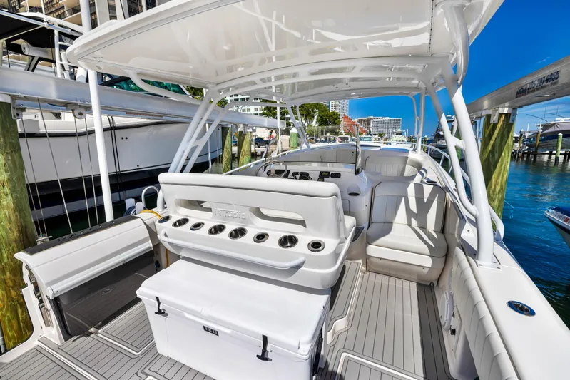  Yacht Photos Pics 2016 Intrepid 400 Cuddy boat interior with seating and fishing rod holders.