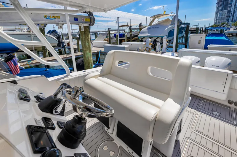  Yacht Photos Pics 2016 Intrepid 400 Cuddy helm station with seating at marina.