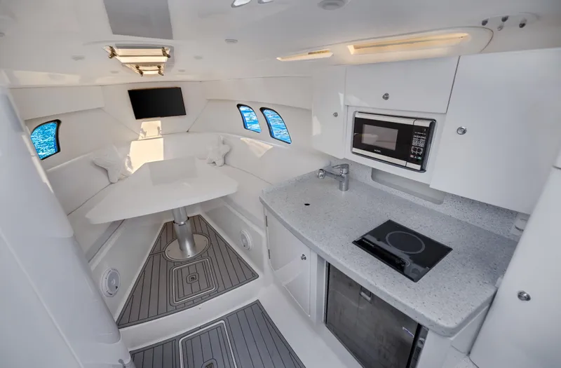  Yacht Photos Pics Interior of a 2016 Intrepid 400 Cuddy boat with modern kitchen and seating area.