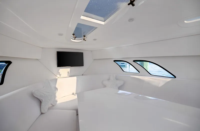  Yacht Photos Pics 2016 Intrepid 400 Cuddy interior with skylight, TV, and star-shaped pillows.