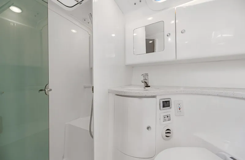  Yacht Photos Pics Modern bathroom in 2016 Intrepid 400 Cuddy boat with shower, sink, and storage cabinets.