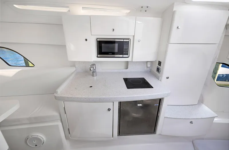  Yacht Photos Pics 2016 Intrepid 400 Cuddy kitchen area with microwave, stove, and refrigerator.