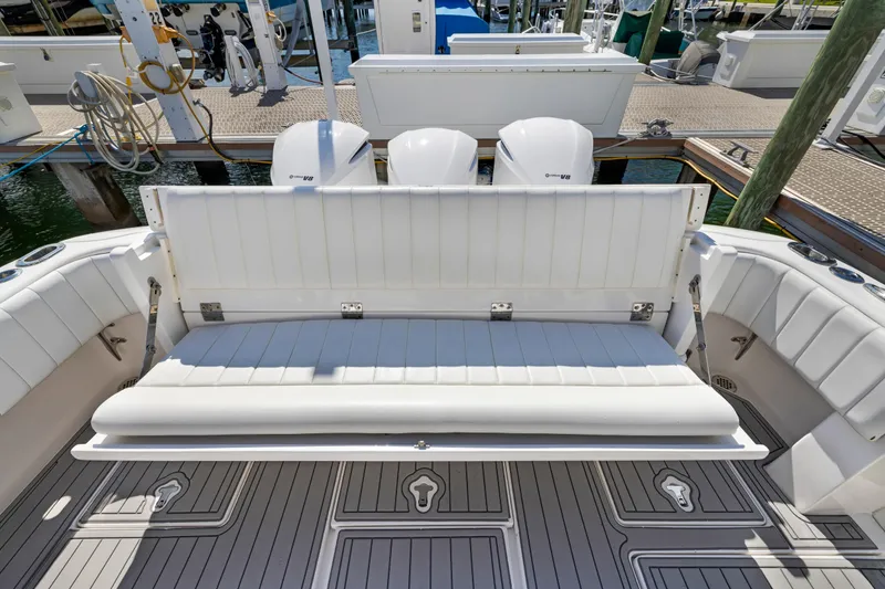  Yacht Photos Pics 2016 Intrepid 400 Cuddy boat with white seating and triple outboard engines at dock.