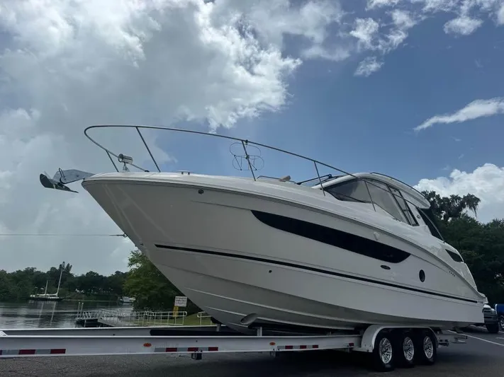  Yacht Photos Pics 2017 Sea Ray Sundancer 350 Coupe on trailer under cloudy sky.