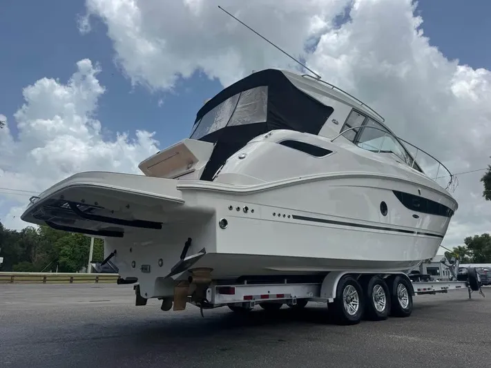  Yacht Photos Pics 2017 Sea Ray Sundancer 350 Coupe on trailer under cloudy sky.