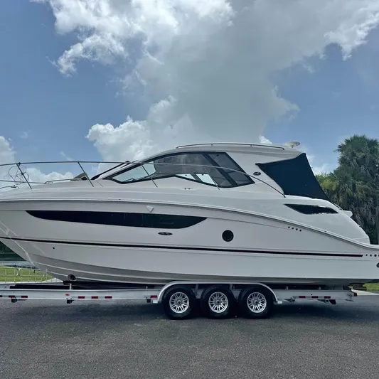  Yacht Photos Pics 2017 Sea Ray Sundancer 350 Coupe on trailer under cloudy sky.