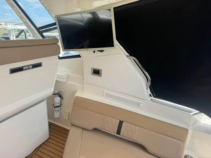  Yacht Photos Pics Interior of 2017 Sea Ray Sundancer 350 Coupe with TV and seating area.