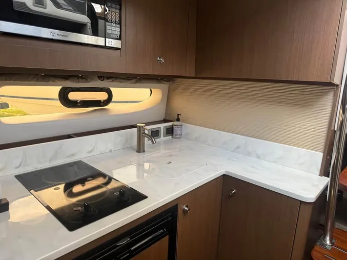  Yacht Photos Pics Modern kitchen interior of 2017 Sea Ray Sundancer 350 Coupe yacht.