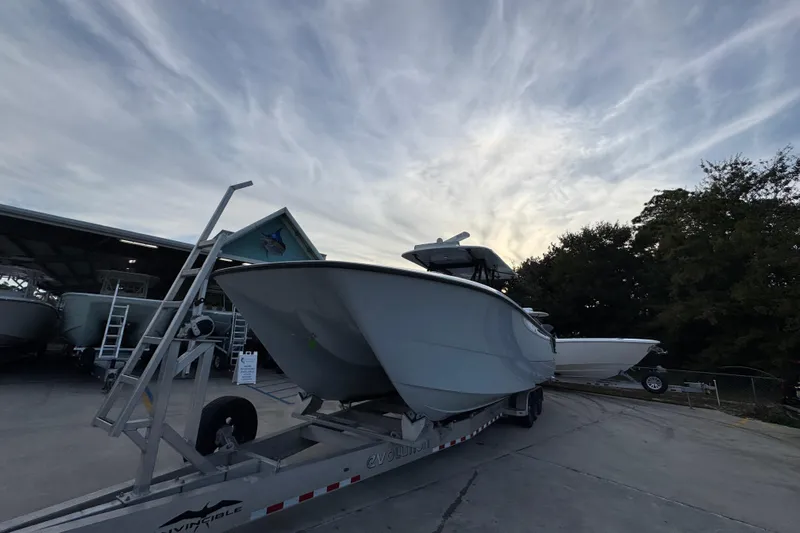  Yacht Photos Pics 2021 Invincible 35' Catamaran on trailer under cloudy sky.