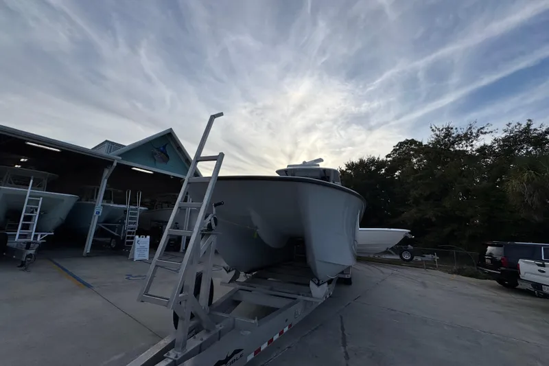  Yacht Photos Pics 2021 Invincible 35' Catamaran on trailer at marina under cloudy sky.