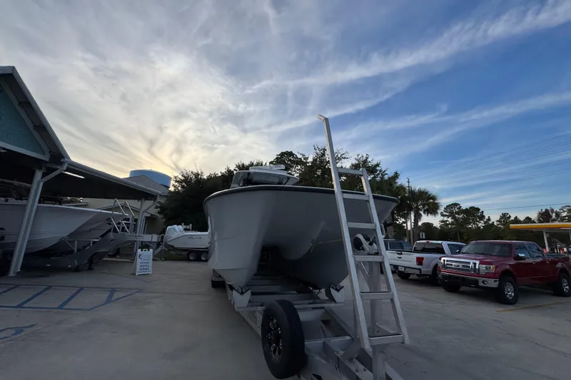  Yacht Photos Pics 2021 Invincible 35' Catamaran on trailer at dealership, under a cloudy sky.