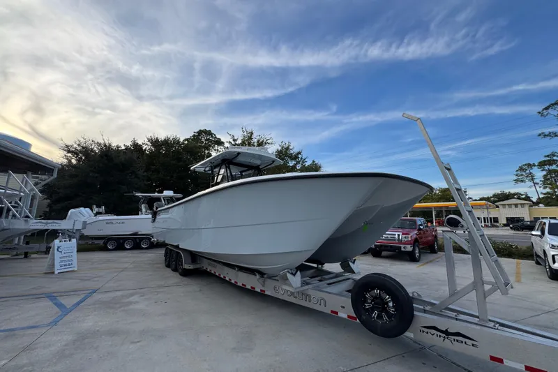  Yacht Photos Pics 2021 Invincible 35' Catamaran on trailer, parked outdoors under a blue sky.