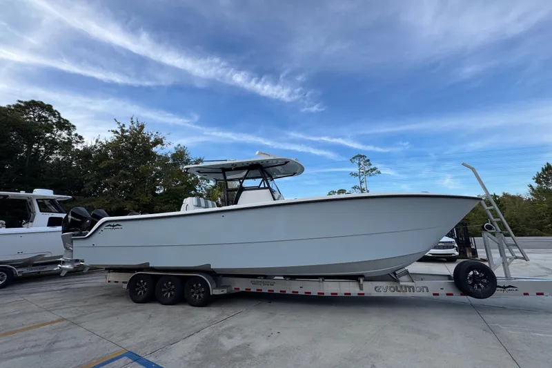  Yacht Photos Pics 2021 Invincible 35' Catamaran on trailer, parked outdoors under a clear sky.
