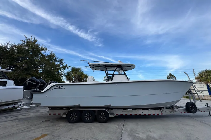  Yacht Photos Pics 2021 Invincible 35' Catamaran on trailer, parked outdoors under blue sky.